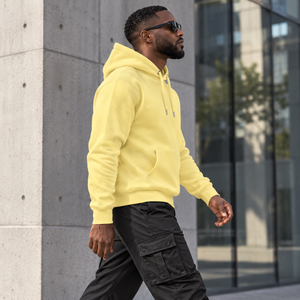 HEAD HELD HIGH bold yellow hoodie — modern city side view